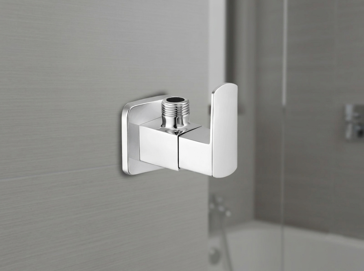 Chrome angle valve with square base mounted on a grey tiled wall