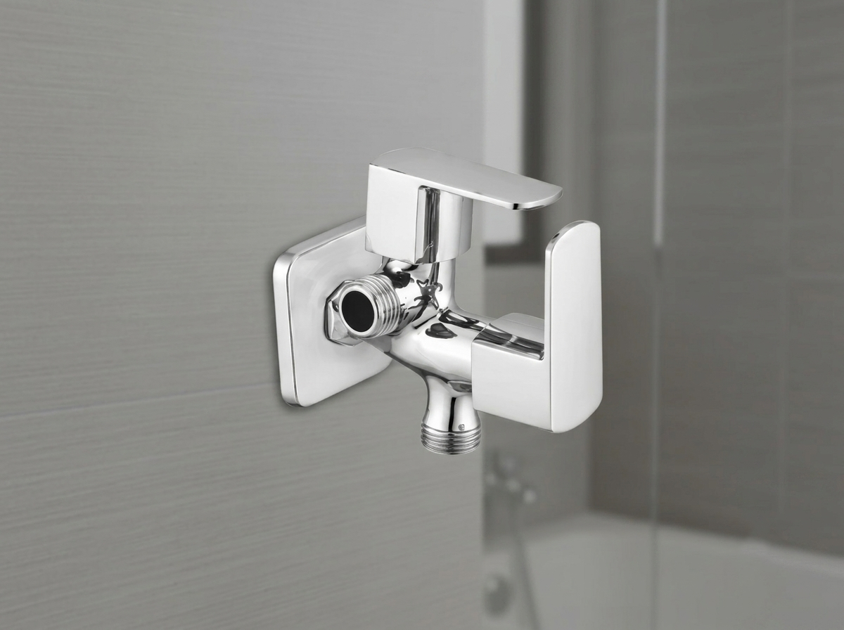 Chrome dual flow angle valve with square handle mounted on a grey tiled wall