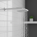 Shower head with water flowing in a bathroom setting